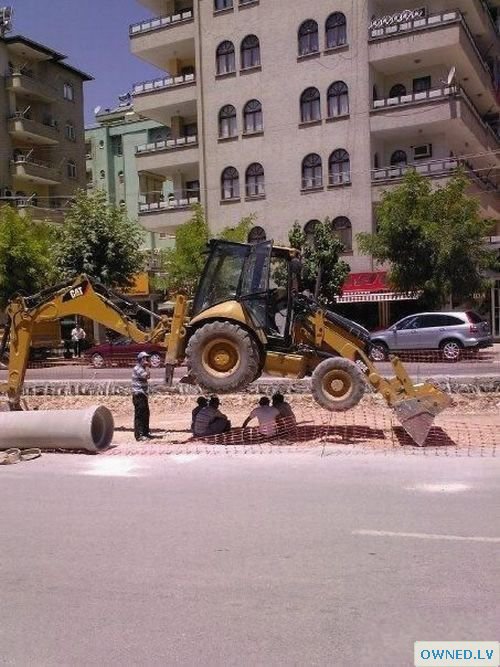Construction workers under a bobcat lol